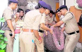 policemen carry her body.