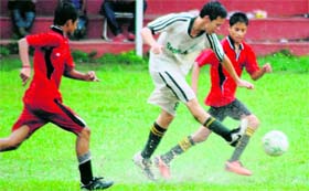 Players of Col Brown School (in white) and Gautam International School (in red) in action in the ONGC Ram Bahadur Chhetri Memorial Football Tournament in Dehradun on Tuesday.