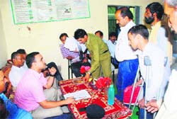 Deputy Commissioner Ritesh Chauhan addresses grievances of a differently abled person at the district-level Prashashan Janata Ke Dwaar Shivir at Chakoh village in Bilaspur district.