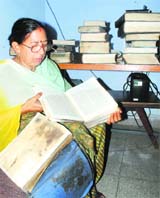 An employee of the library tries to salvage the books. 