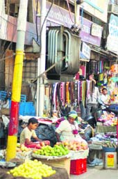Unmindful of the risk involved, vendors put up their stalls under a power transformer near the City Chowk in Jammu. 