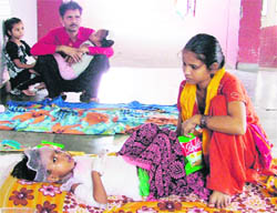 Sanya (5), a burns patient, lies on the floor of the waiting hall of the Civil Hospital. She was shifted here due to the death of another patient in the burns ward.
