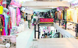 The AC Market sans CCTV cameras; and (inset) a sealed shop at the AC Market, where CCTV cameras have been dumped