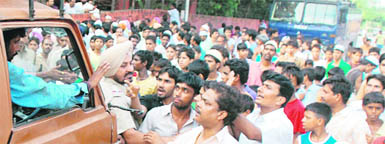 Residents of Maloya stop a truck opposite the Sector-39 police station in Chandigarh on Wednesday. 