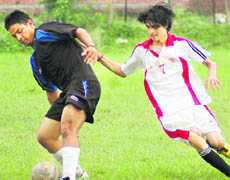 Players in action in a match between DBS College, Dehradun (in black), and Government College, Rishikesh (in white), in the Hemwati Nandan Bahuguna Garhwal University Inter-Collegiate Football Tournament in Dehradun 