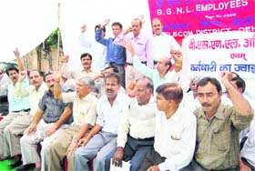 BSNL Employees Union members hold a protest in support of their demands in Dehradun on Wednesday
