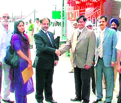 Indian railway officials greet their counterparts from Pakistan at the Attari-Wagah joint check-post in Amritsar on Wednesday