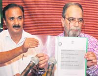 Director, Census Operations, Farooq Ahmad Factoo (right), releases the second paper of the Census-2011 report in Srinagar on Wednesday