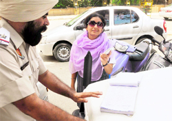 A student seen insisting the traffic policeman to talks to her contact on a phone to avoid being challaned during a drive launched by the police in Ludhiana
