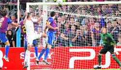 AC Milan's Thiago Silva scores a header against Barcelona