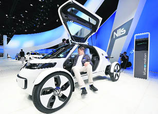 A visitor inspects the electric Nils concept car by German car maker Volkswagen during the international motor show IAA (Internationale Automobil-Ausstellung) in Frankfurt on Thursday