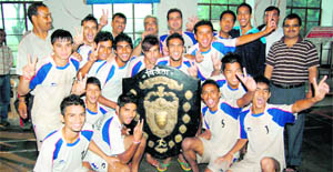The DAV PG College, Dehradun, team with the Hemwati Nandan Bahuguna Garhwal University Inter-Collegiate Football Tournament trophy in Dehradun on Thursday. 