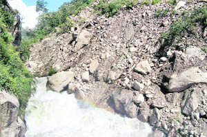 A landslide at Kili Parli near the Sainj power project dam site has squeezed the Sainj river into a narrow stream. 