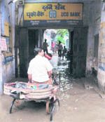 A rickshaw-puller stuck on a waterlogged road in Ludhiana.