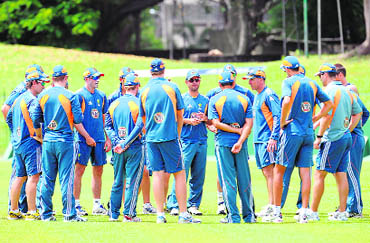 Australian coach Tim Nielsen (5R) gives instructions to players during a practice session at The SSC Ground in Colombo on Thursday