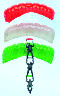 Skydivers (left) showcase their skill during the 60th anniversary celebrations of the Golden Arrows, 17 Squadron of the Indian Air Force, at the Air Station in Bhisiana near Bathinda on Friday