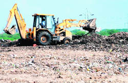 A JCB machine at work on the dumping ground in Sector 23 of Panchkula.