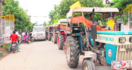 An ambulance gets stuck as tractors used in campaigning for SGPC elections line up at Mohali