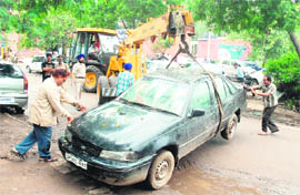 Employees of the municipal corporation tow away a vehicle from Sector 38 (West) in Chandigarh