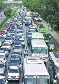 Waterlogging near Yamuna Bazar caused a traffic jam on Ring Road in New Delhi on Friday. 