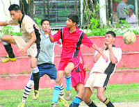 Players of Kendriya Vidyalaya, FRI (in light brown) and Kendriya Vidyalaya, ONGC (in red) in action in a match in the Ram Bahadur Chhetri Memorial Football Tournament in Dehradun