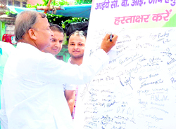 A man puts his signature in support of a campaign for a CBI probe into alleged Maha Kumbh fund irregularities in Haridwar on Friday