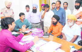 Punjabi NRIs who were displaced from Libya narrate their tale of woes to Regional Passport Officer Parneet Singh on Wednesday. 