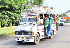 An overloaded mini-bus at Satwari Chowk in Jammu. In the absence of proper check, such violations by private transporters are common in the city.