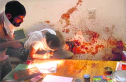 Forensic experts examine the crime scene in Sant Nagar.