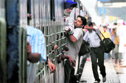 With trains running late by several hours, passengers hang out of overcrowded trains proceeding to Amritsar and Jammu, in Ludhiana on Friday