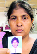 Munni Devi with a photo of her son