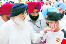 Chief Minister Parkash Singh Badal consoles Harman Sandhu, grandson of the deceased MLA JS Kariha