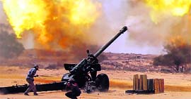 Anti-Gaddafi fighters fire at pro-Gaddafi forces east of Sirte on Friday.