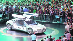Visitors at the 64th International Motor Show watch a Mercedes-Benz fuel cell show car "F125" at the Mercedes-Benz exhibition in Frankfurt