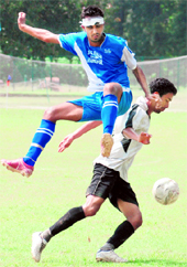 Players in action during a football match held between SGGS Khalsa College, Mahilpur, and Gurusar Sadhar at Panjab University in CVhandigarh on Saturday