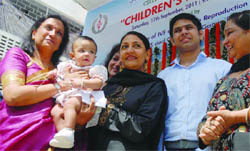 Abha Majumdar (L), HOD, Centre for IVF & Human Reproduction, Sir Ganga Ram Hospital, and actor and activist Deepti Naval (C) pose with the first IVF baby, Garv, and his mother during the 20-year celebrations of the 