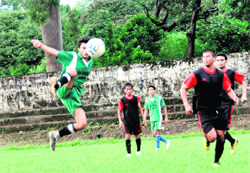A player of Garhwal Sporting Club (in green) in action in a match against Doon Valley Club (in black) in the Doon Collisto Football Tournament in Dehradun on Saturday