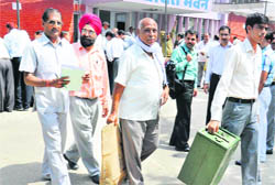 On the eve of the SGPC elections, polling staff head for polling stations, carrying election material, in Karnal 