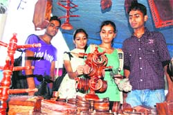 Youngsters look at handicrafts on display at a trade fair in Dharamsala 