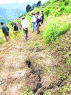 Cracks develop in the fields of Kadwar Reshan village in Mandi district. 
