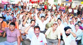 Members of the Northern Railway Mazdoor Union stage a protest in Jammu on Saturday. 