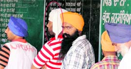 In contravention of the Supreme Court guidelines, a Sehajdhari Sikh (encircled) stands to cast his vote at Landran village, Mohali, during the SGPC poll on Sunday.