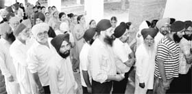 Voters queue up outside a polling booth at Sector 27 in Chandigarh on Sunday. 