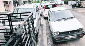 With little parking space available, residents have parked their vehicles on a road, blocking more than half of it, in Sector 46.