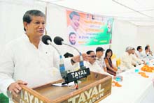 Union Minister of State for Agriculture, Food Processing and Parliamentary Affairs Harish Rawat addresses a public meeting in Dehradun on Sunday. 