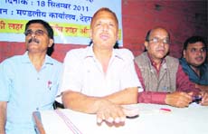 PC Tiwari, president of the Uttarakhand Parivartan Party, addresses mediapersons in Dehradun on Sunday. 