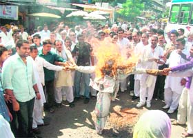 INLD activists led by state INLD president and local MLA Ashok Arora burn an effigy of the UPA government in protest against the petrol price hike near Maharana Pratap Chowk in Kurukshetra on Sunday