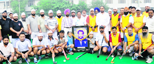 Team members of the Olympian Surjit Club and Mohinder Munshi Club pose with a picture of Olympian Mohinder Singh Munshi in Jalandhar on Sunday
