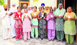 Voters of Purain village in the Sidhwan constituency whose names were not on the voter list in Ludhiana on Sunday. Tribune photos: Himanshu Mahajan