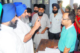 Candidate KS Manan argues with the presiding officer in Jalandhar on Sunday. 